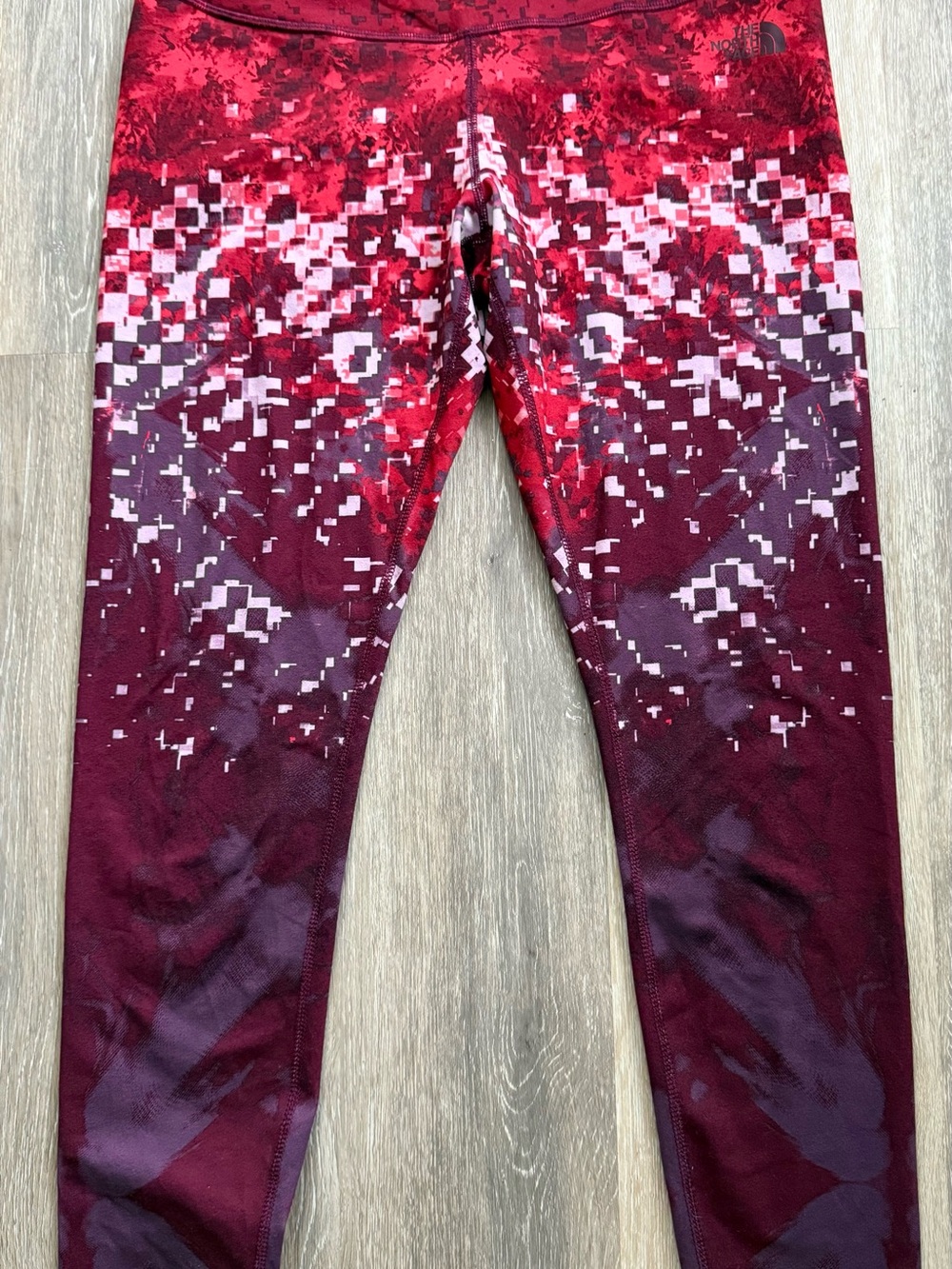 The North Face Red and Burgundy Pixel-Print Active workout tights.